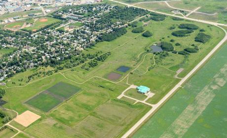 Ariel photo of the City of Yorkton’s new water treatment plant. It features the treatment centre on a wide swath of green space, with two sedimentation ponds in the distance.